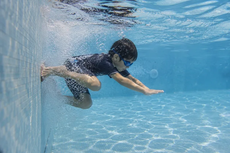 A child moving independently beneath the water