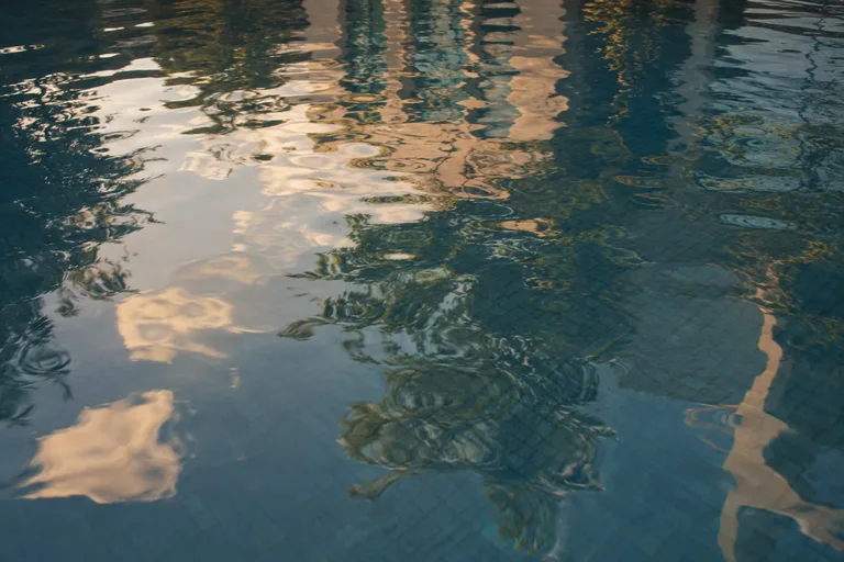 Late afternoon light reflected across quiet pool water